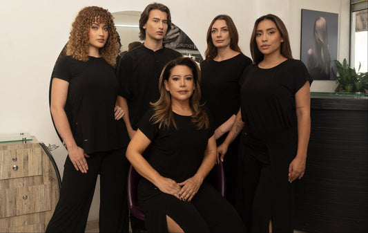 Salonwear brand for women showcasing modern black outfits on beauty artists and stylists in a lifestyle setting